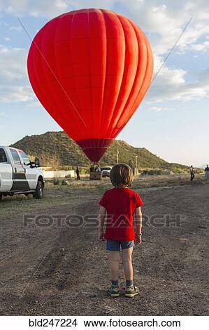 Caucasian boy watching distant hot air balloon View Large Photo Image Picture - Caucasian boy watching distant hot air balloon. Fotosearch
