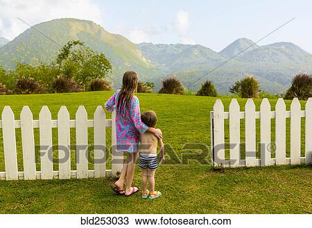 Caucasian brother and sister admiring scenic view of mountains View Large Photo Image Stock Image - Caucasian brother and sister admiring scenic view of mountains. Fotosearch