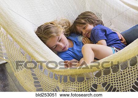 Caucasian brother and sister cuddling in hammock View Large Photo Image Stock Image - Caucasian brother and sister cuddling in hammock. Fotosearch