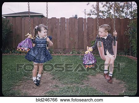 Caucasian brother and sister on swings holding Easter baskets View Large Photo Image Stock Photograph - Caucasian brother and sister on swings holding Easter baskets. Fotosearch
