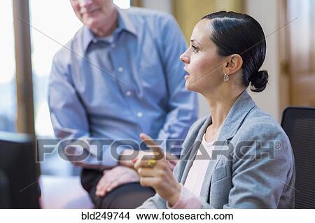 Picture - Caucasian business people talking in office. Fotosearch
