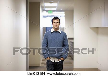 Caucasian businessman standing in office View Large Photo Image Picture - Caucasian businessman standing in office. Fotosearch