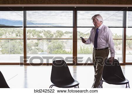 Caucasian businessman texting on cell phone View Large Photo Image Stock Image - Caucasian businessman texting on cell phone. Fotosearch