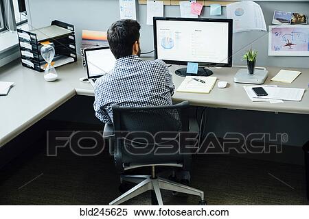 Caucasian businessman using laptop and computer in office View Large Photo Image Stock Photography - Caucasian businessman using laptop and computer in office. Fotosearch