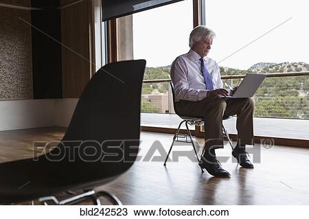 Stock Image - Caucasian businessman using laptop. Fotosearch