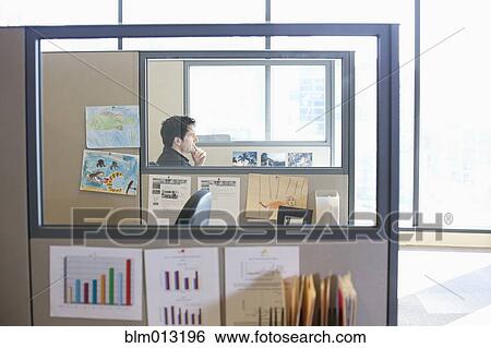 Caucasian businessman working in cubicle View Large Photo Image Stock Photograph - Caucasian businessman working in cubicle. Fotosearch