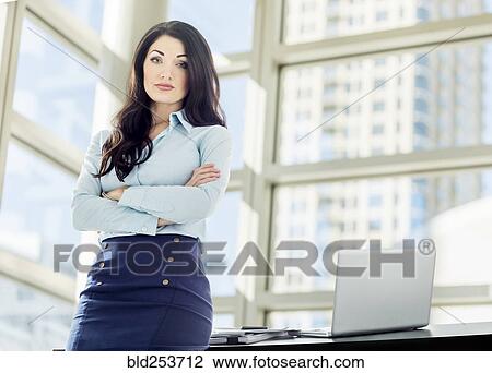 Stock Image - Caucasian businesswoman posing in office. Fotosearch