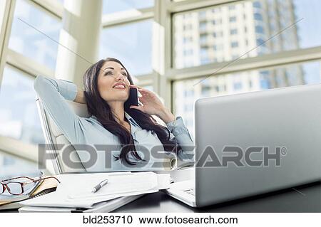 Stock Image - Caucasian businesswoman talking on cell phone. Fotosearch