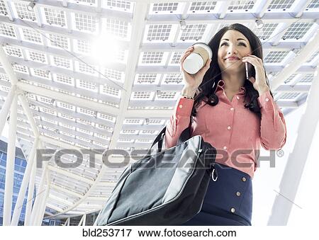 Stock Photo - Caucasian businesswoman talking on cell phone. Fotosearch