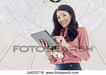 Caucasian businesswoman using digital tablet View Large Photo Image Stock Photograph - Caucasian businesswoman using digital tablet. Fotosearch