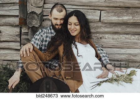 Caucasian cockle sitting in the grass leaning on wooden wall View Large Photo Image Stock Image - Caucasian cockle sitting in the grass leaning on wooden wall. Fotosearch