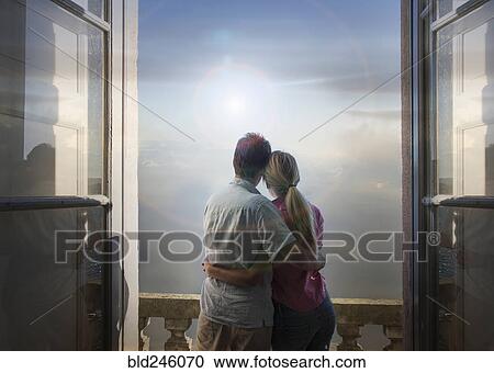 Caucasian couple admiring scenic view of lake from balcony View Large Photo Image Stock Image - Caucasian couple admiring scenic view of lake from balcony. Fotosearch