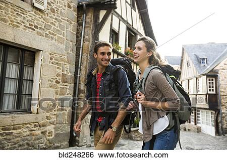 Stock Photograph - Caucasian couple backpacking in city. Fotosearch