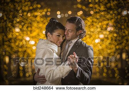 Picture - Caucasian couple dancing at night. Fotosearch