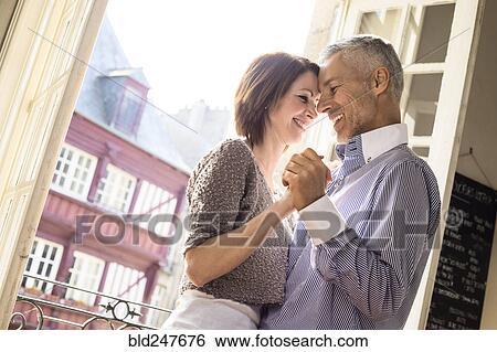 Stock Photograph - Caucasian couple dancing near doorway. Fotosearch