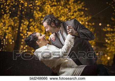 Caucasian couple dancing outdoors at night View Large Photo Image Stock Photograph - Caucasian couple dancing outdoors at night. Fotosearch