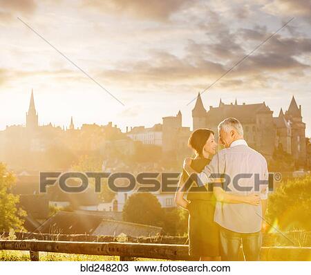 Stock Image - Caucasian couple enjoying scenic view. Fotosearch