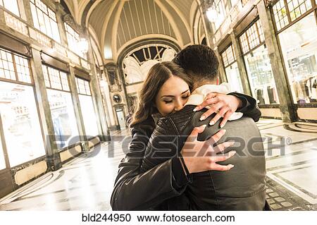 Caucasian couple hugging in lobby View Large Photo Image Stock Image - Caucasian couple hugging in lobby. Fotosearch