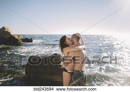 Caucasian couple hugging in ocean View Large Photo Image Picture - Caucasian couple hugging in ocean. Fotosearch