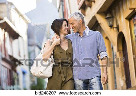Caucasian couple hugging in the city View Large Photo Image Stock Photo - Caucasian couple hugging in the city. Fotosearch