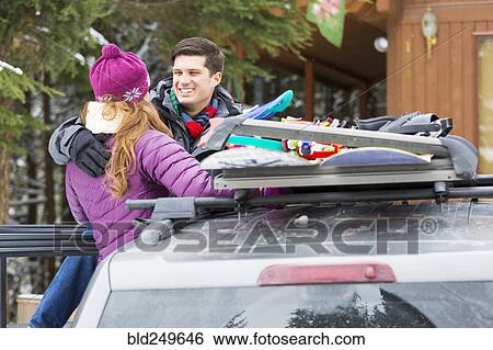 Caucasian couple hugging near snowboards in car roof rack View Large Photo Image Stock Photograph - Caucasian couple hugging near snowboards in car roof rack. Fotosearch