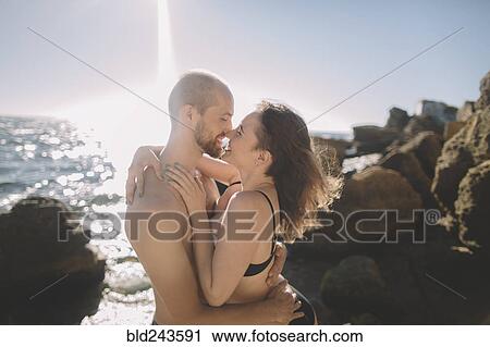 Caucasian couple hugging on beach View Large Photo Image Stock Image - Caucasian couple hugging on beach. Fotosearch