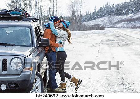 Caucasian couple kissing near car in winter View Large Photo Image Stock Image - Caucasian couple kissing near car in winter. Fotosearch