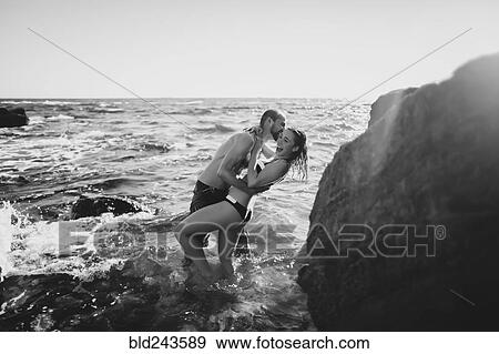 Caucasian couple laughing in ocean waves View Large Photo Image Stock Photo - Caucasian couple laughing in ocean waves. Fotosearch