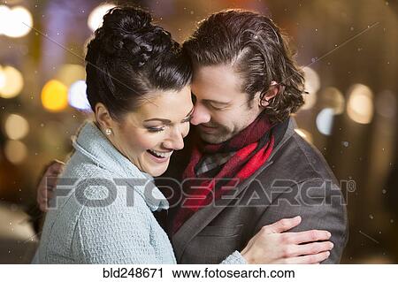 Caucasian couple laughing outdoors at night View Large Photo Image Stock Image - Caucasian couple laughing outdoors at night. Fotosearch