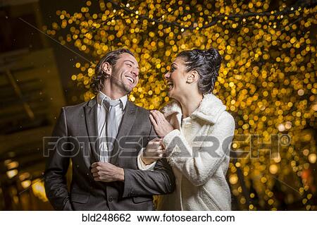 Stock Image - Caucasian couple laughing outdoors. Fotosearch