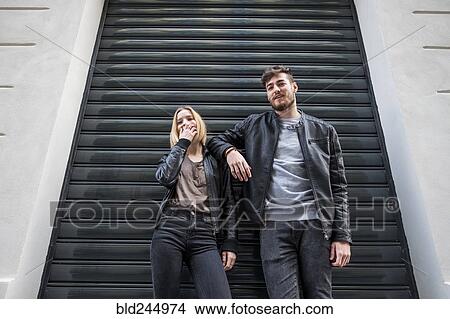 Picture - Caucasian couple leaning on doorway gate. Fotosearch
