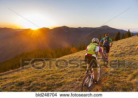 Caucasian couple mountain biking on trail View Large Photo Image Picture - Caucasian couple mountain biking on trail. Fotosearch