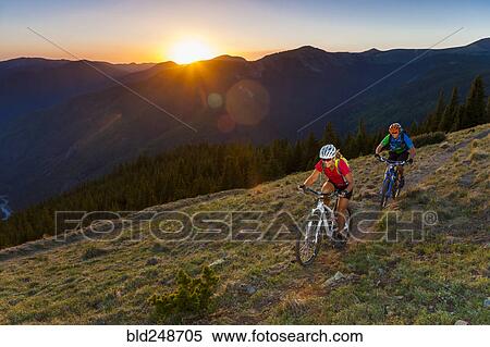 Caucasian couple mountain biking on trail View Large Photo Image Stock Photography - Caucasian couple mountain biking on trail. Fotosearch
