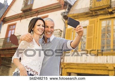 Caucasian couple posing for cell phone selfie View Large Photo Image Stock Photography - Caucasian couple posing for cell phone selfie. Fotosearch