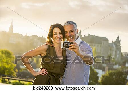Caucasian couple posing for selfie View Large Photo Image Stock Image - Caucasian couple posing for selfie. Fotosearch