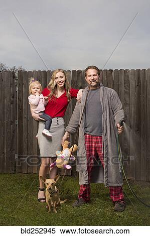 Caucasian couple posing near wooden fence with baby daughter View Large Photo Image Stock Photography - Caucasian couple posing near wooden fence with baby daughter. Fotosearch