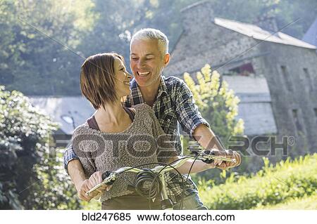 Stock Photography - Caucasian couple riding bicycle. Fotosearch