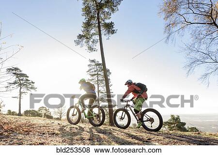 Stock Photo - Caucasian couple riding bicycles. Fotosearch