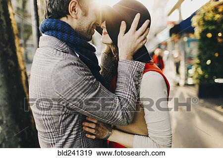 Stock Photo - Caucasian couple rubbing noses on sunny day. Fotosearch