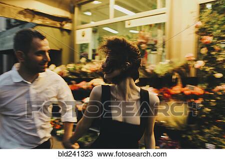 Caucasian couple rushing near florist View Large Photo Image Stock Image - Caucasian couple rushing near florist. Fotosearch