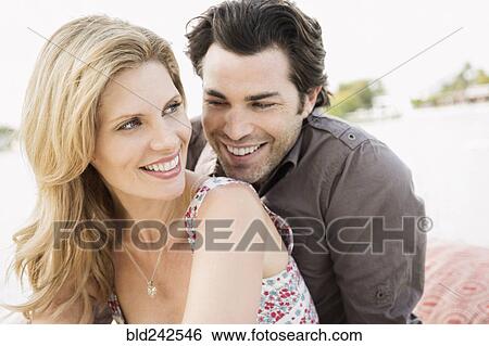 Caucasian couple smiling outdoors View Large Photo Image Stock Photograph - Caucasian couple smiling outdoors. Fotosearch