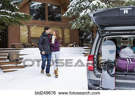 Caucasian couple walking to car with snowboards in winter View Large Photo Image Stock Photograph - Caucasian couple walking to car with snowboards in winter. Fotosearch