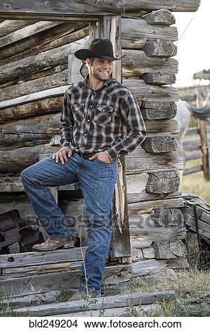 Caucasian cowboy leaning in doorway of cabin View Large Photo Image Picture - Caucasian cowboy leaning in doorway of cabin. Fotosearch