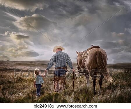 Stock Photography - Caucasian father and daughter walking horse in field. Fotosearch