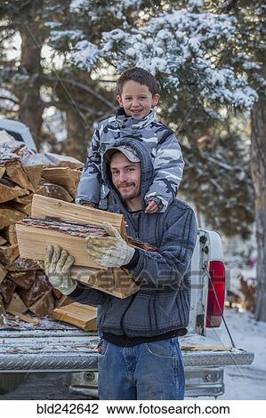 Caucasian father and son carrying firewood from truck View Large Photo Image Stock Image - Caucasian father and son carrying firewood from truck. Fotosearch