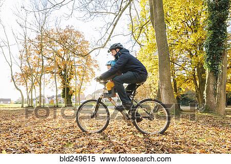 Stock Photography - Caucasian father and son riding bicycle. Fotosearch