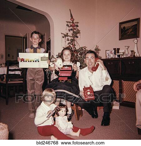 Caucasian father with son and daughters posing with Christmas gifts View Large Photo Image Stock Photo - Caucasian father with son and daughters posing with Christmas gifts. Fotosearch