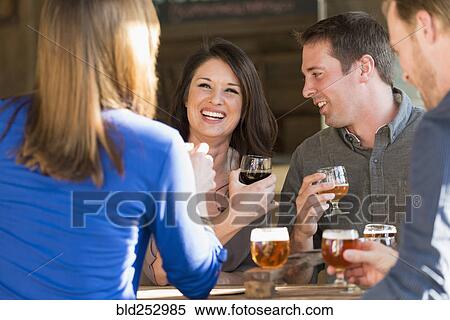 Caucasian friends drinking beer in brew pub View Large Photo Image Stock Photography - Caucasian friends drinking beer in brew pub. Fotosearch