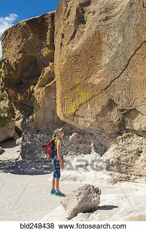 Stock Photo - Caucasian girl admiring rocks while hiking. Fotosearch