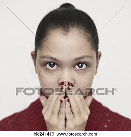 Stock Photo - Caucasian girl covering mouth with hands. Fotosearch